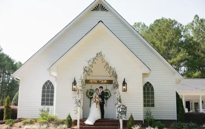 Chloe and Jake infront of Evergreen Chapel | Autumn Altar